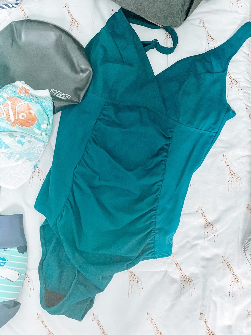 items you need for taking a baby swimming flatlay and adult swim suit from halocline