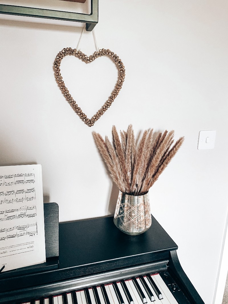 image of a vase with pampas grass on a piano