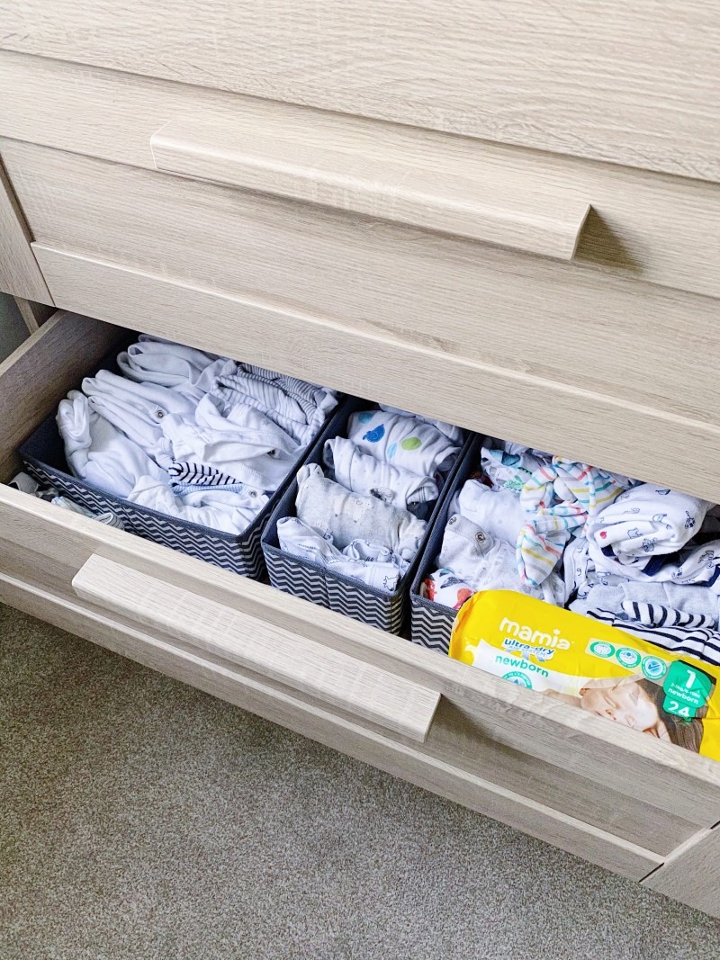 baby clothes in a drawer