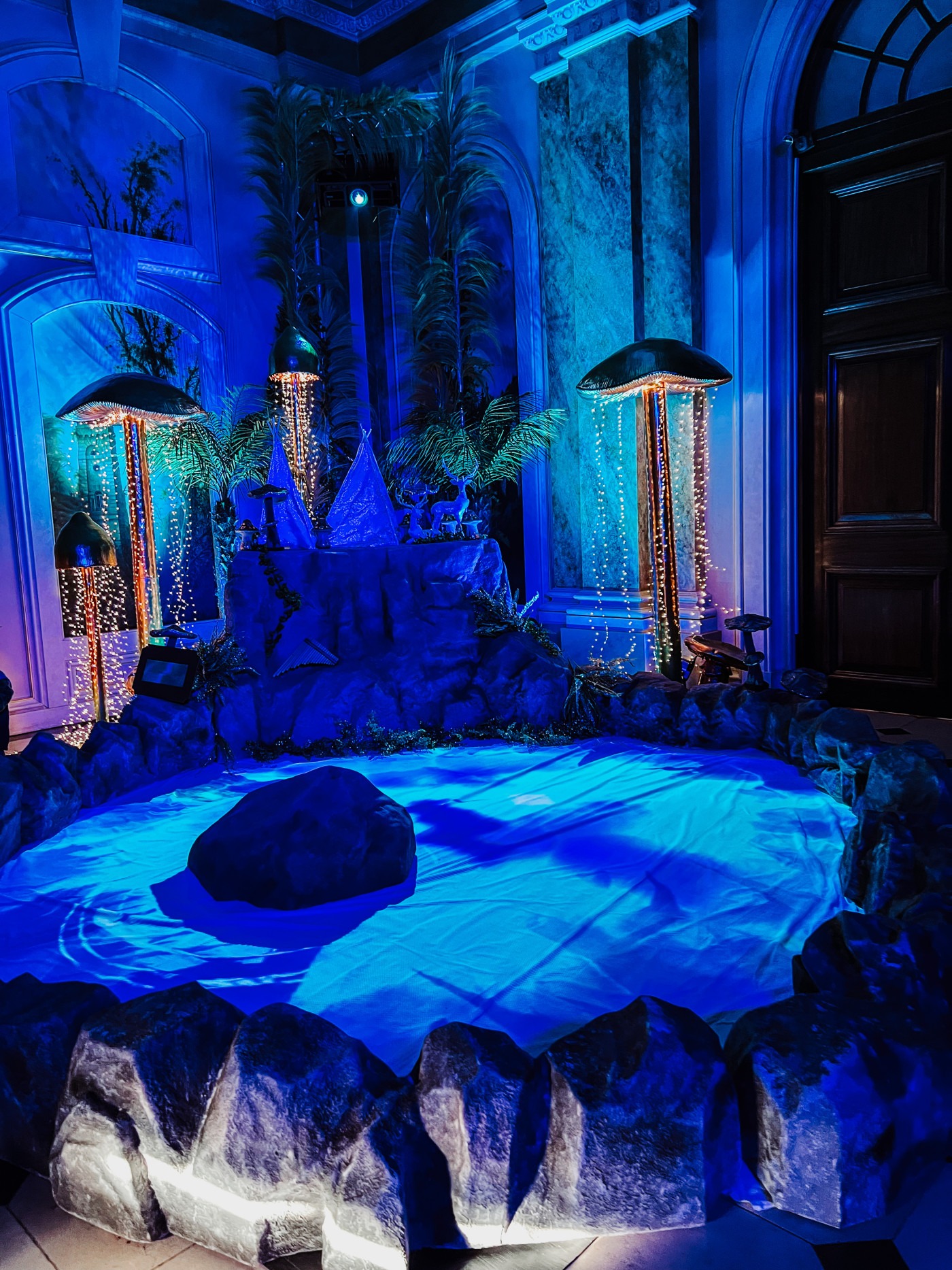 Mermaid's Lagoon room at Castle Howard Christmas with underwater projections and jellyfish lights on the floor