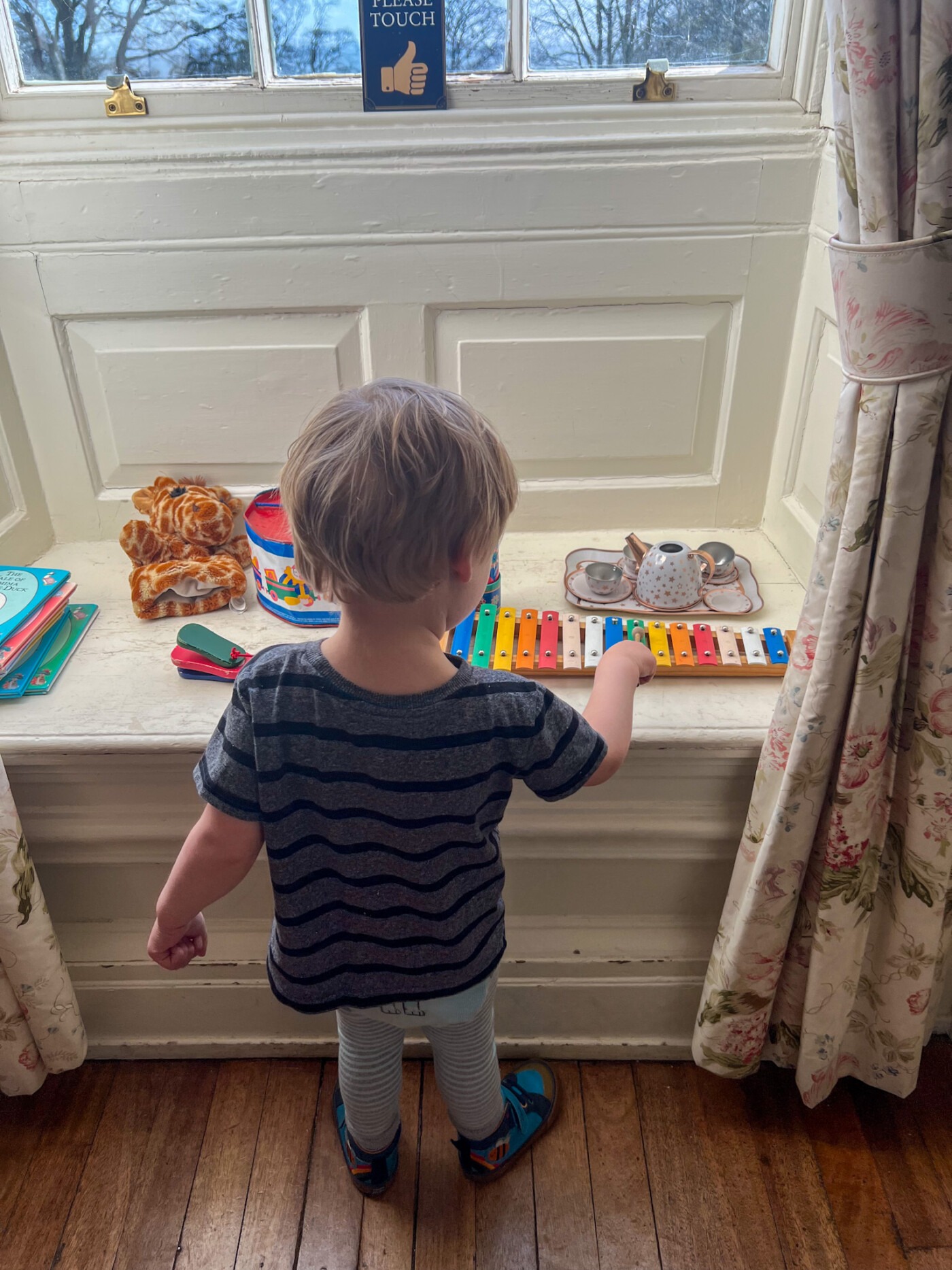 A toddler playing with the interactive toys inside one of the rooms at Sewerby Hall