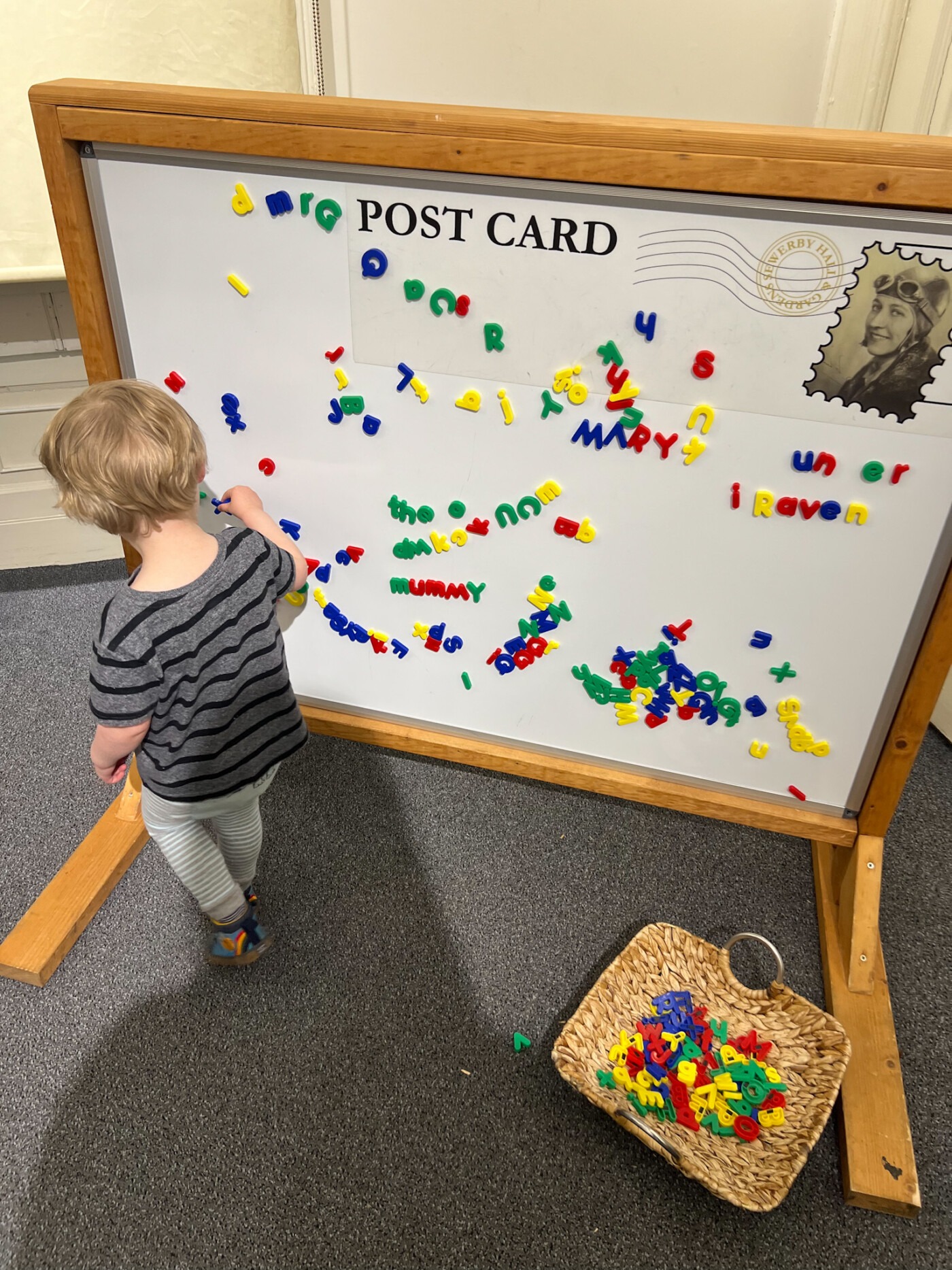A toddler playing with the interactive magnetic letter board inside one of the rooms at Sewerby Hall