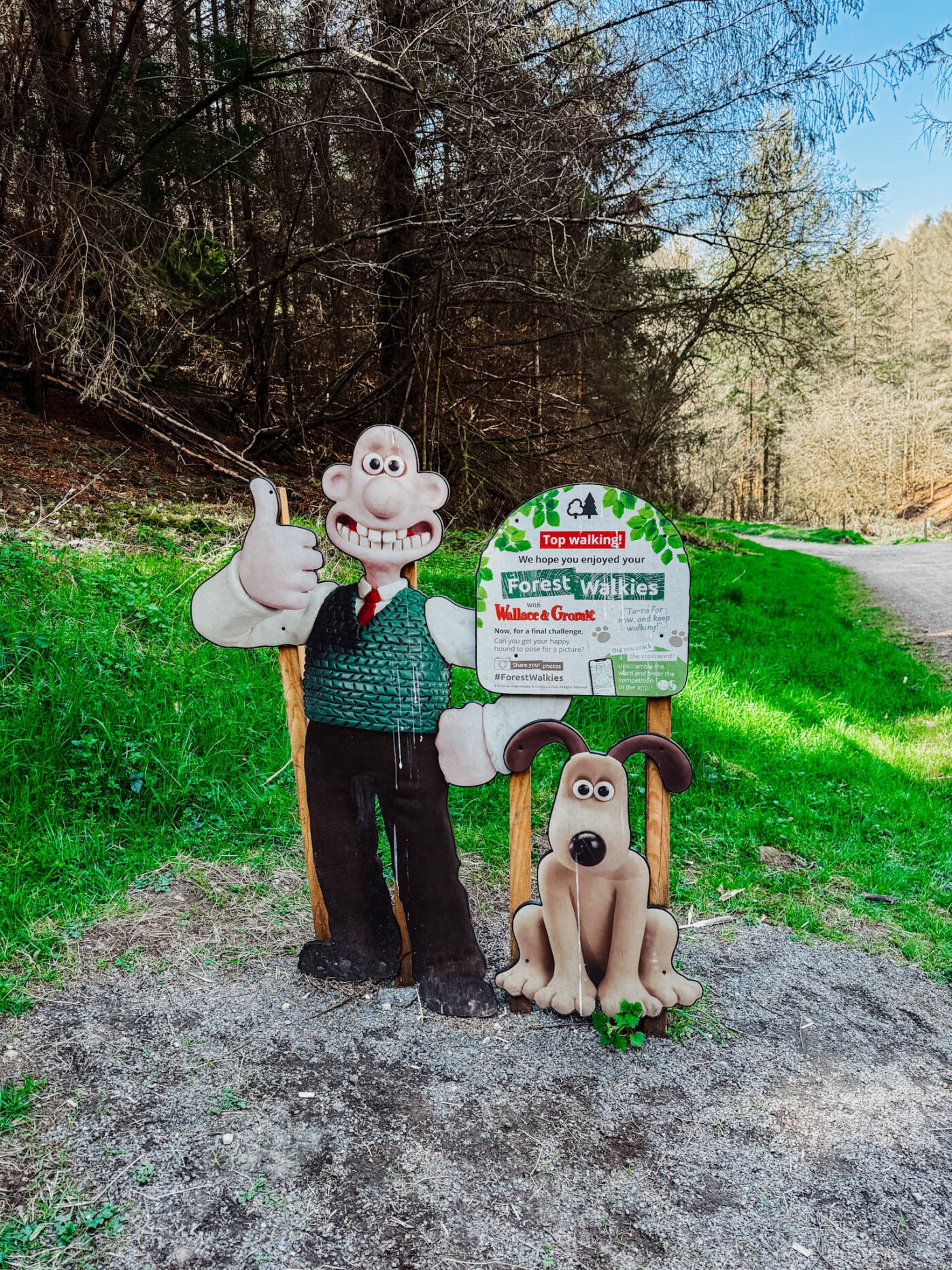 Wallace and Gromit Forest Walkies trail sign at Dalby Forest with incline path visible behind