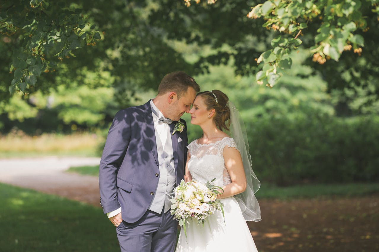 Bride and Groom Standing in a Park
