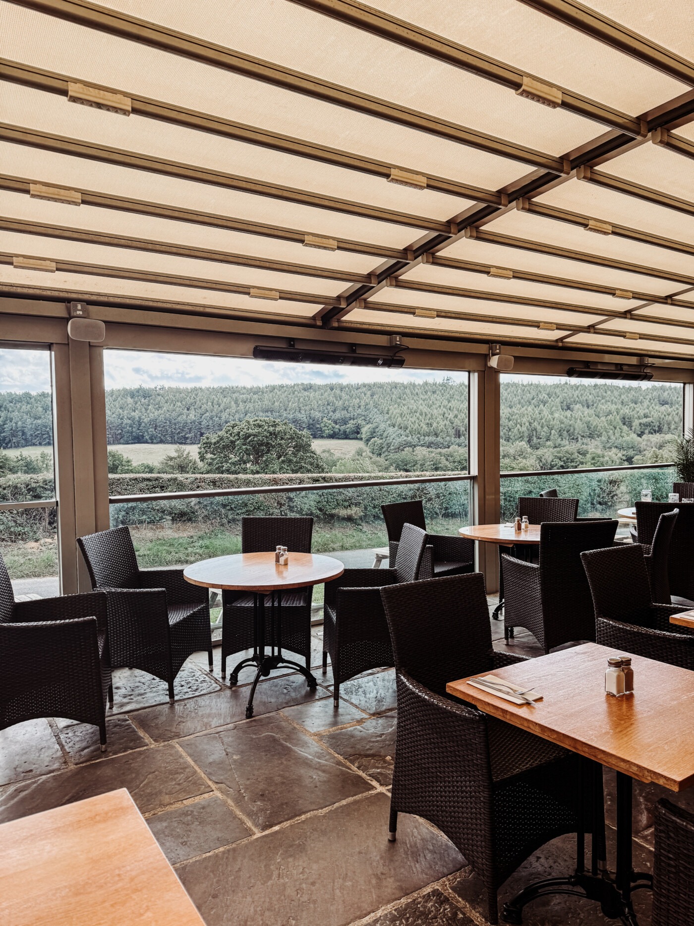 Glass-fronted terrace restaurant at The Stone Trough Inn looking out over the River Derwent and Yorkshire countryside