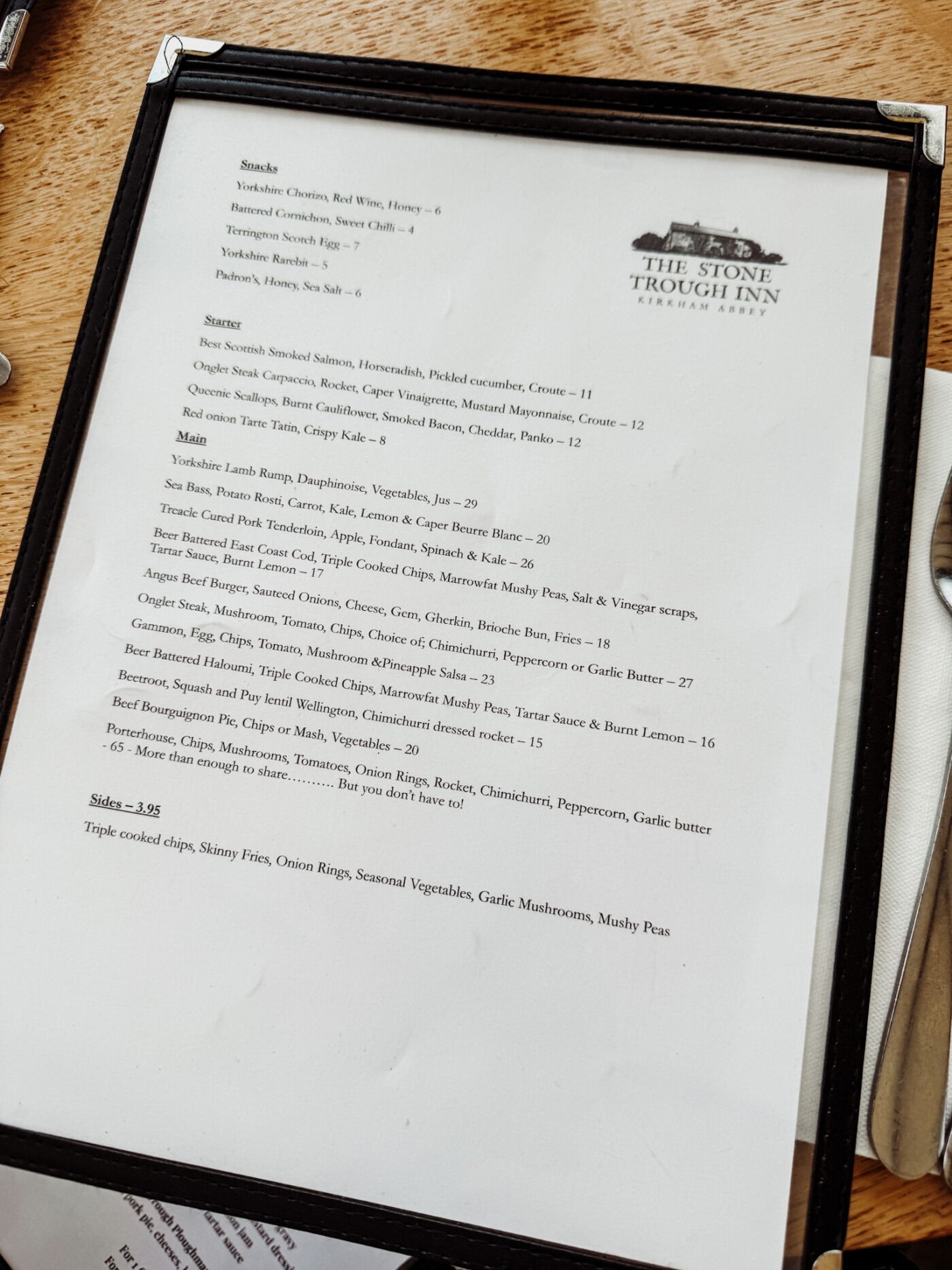 Stone Trough Inn menu showing locally sourced dishes including steak, lamb shank and beer-battered fish