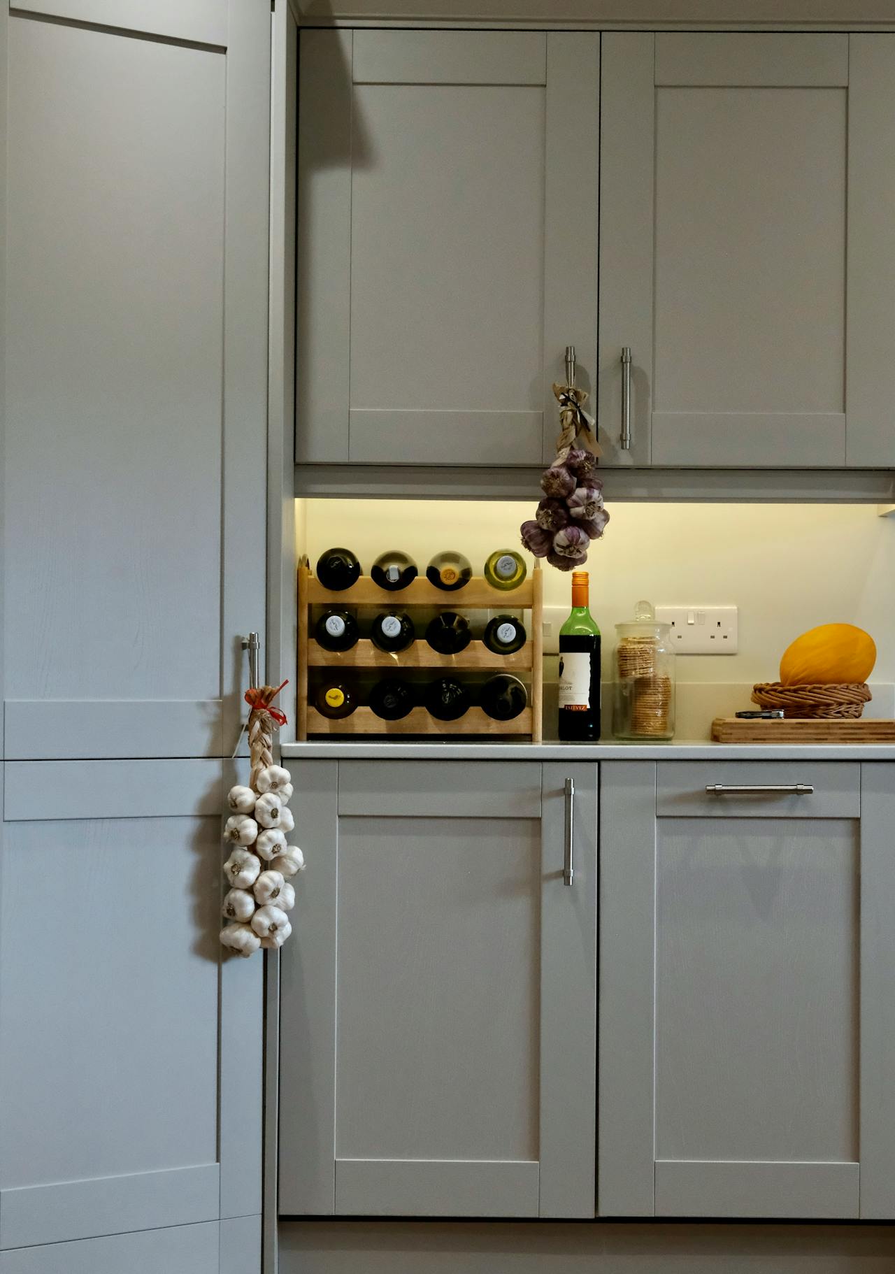 Cosy Kitchen Interior with Wine Rack and Garlic