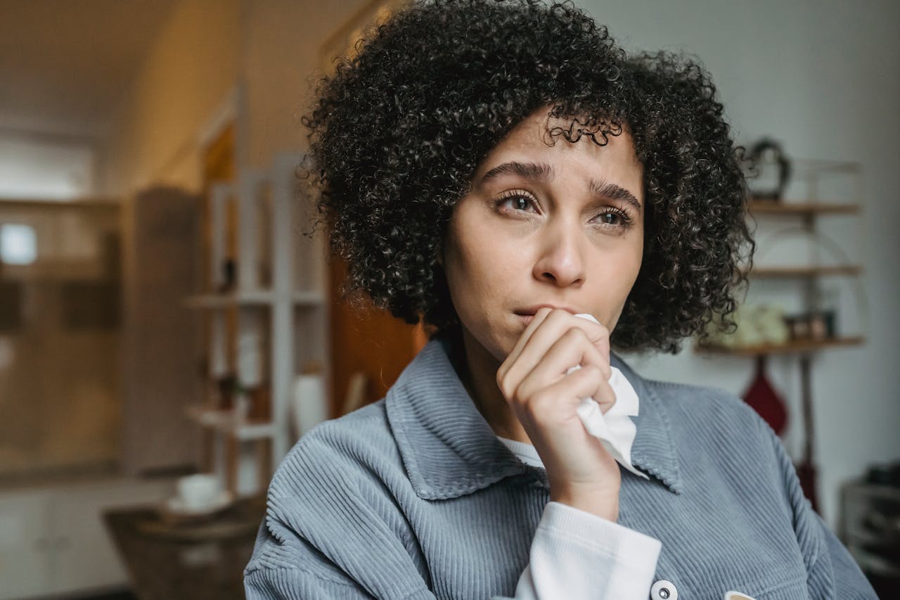 Crying upset black female with tissue