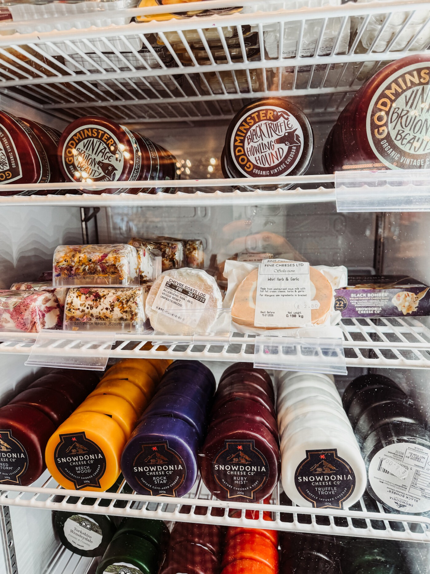 Local produce and condiments on the shelves at Malton Relish deli in Malton Market Place - cheese fridge