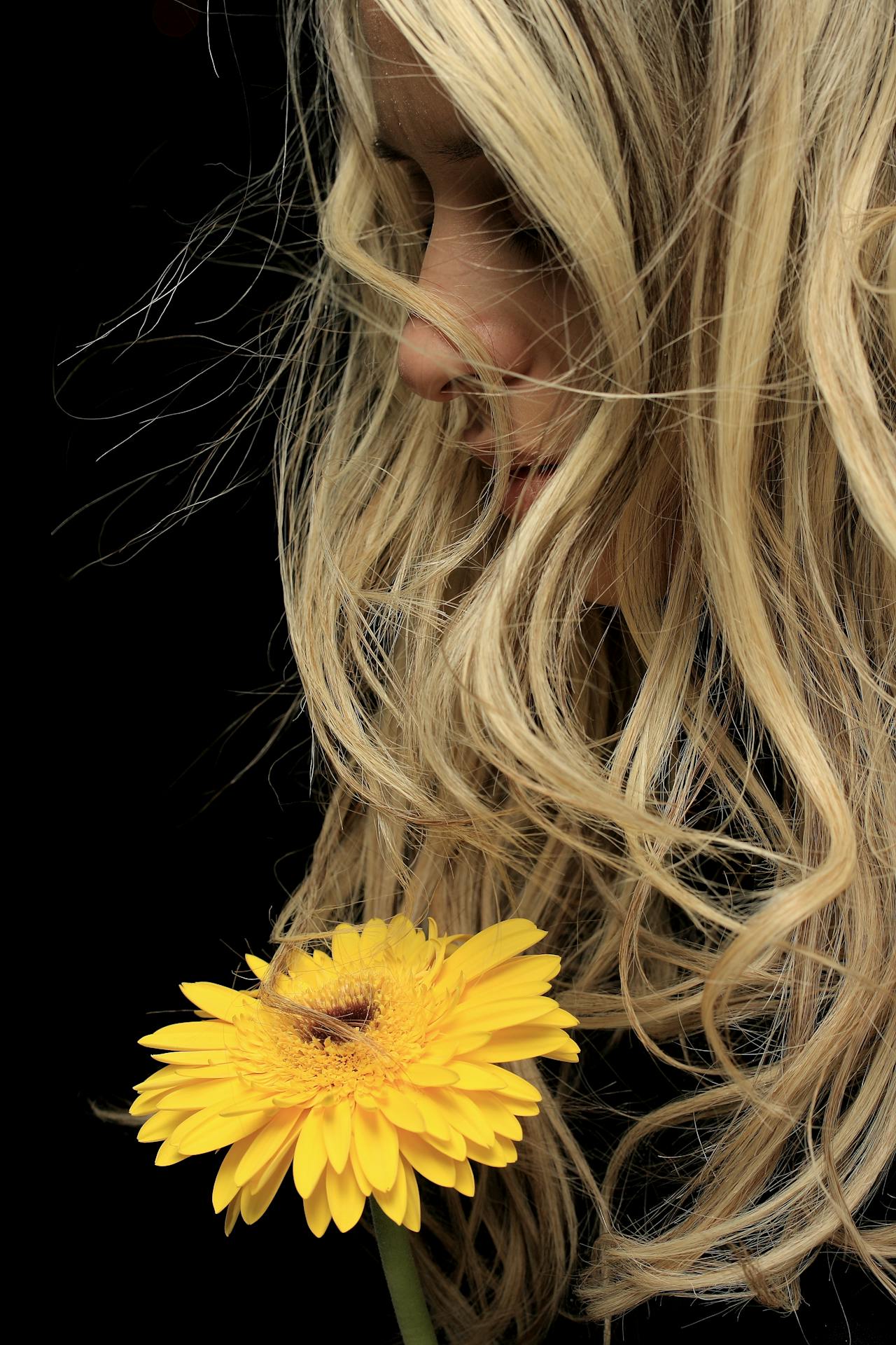 Close-Up Photo of Woman Near Flower