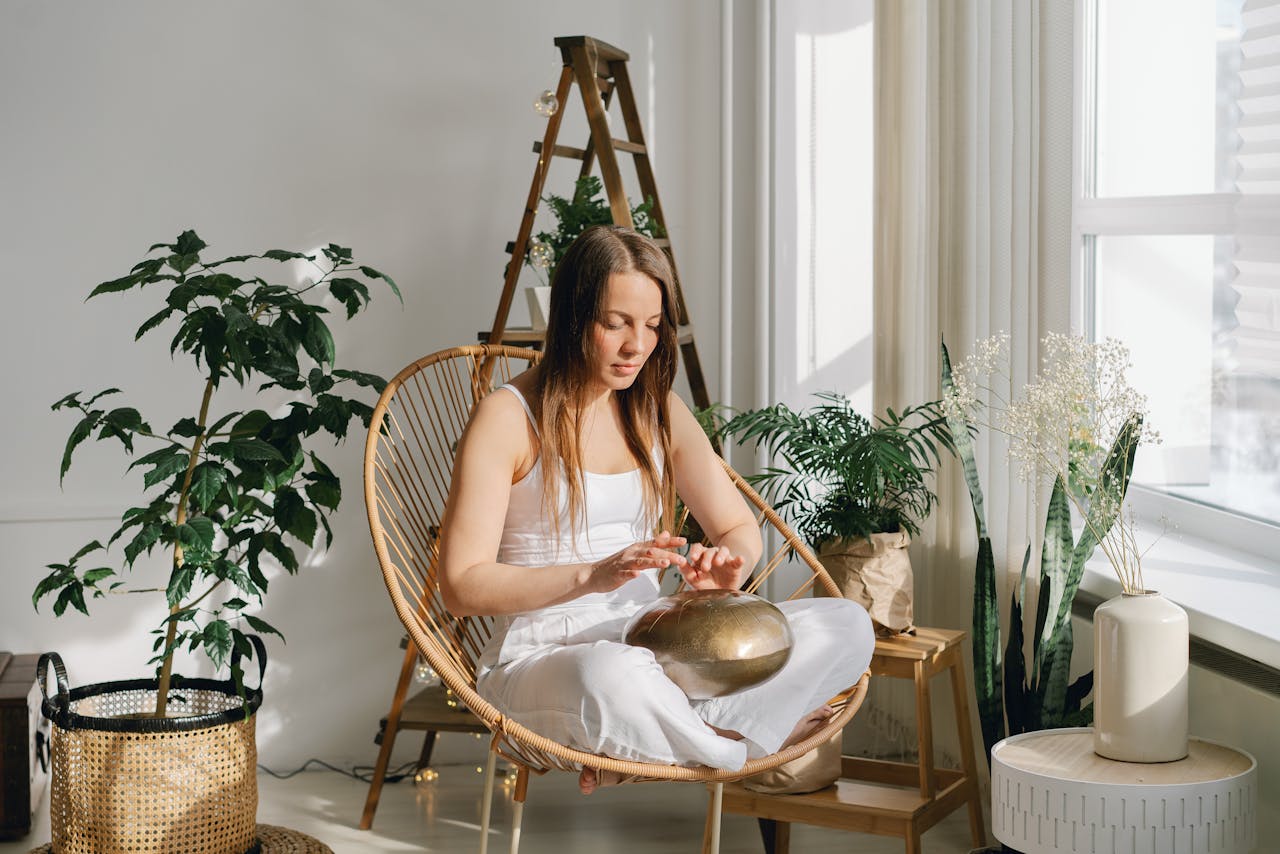 A Woman Sitting on Wicker Chair Meditating