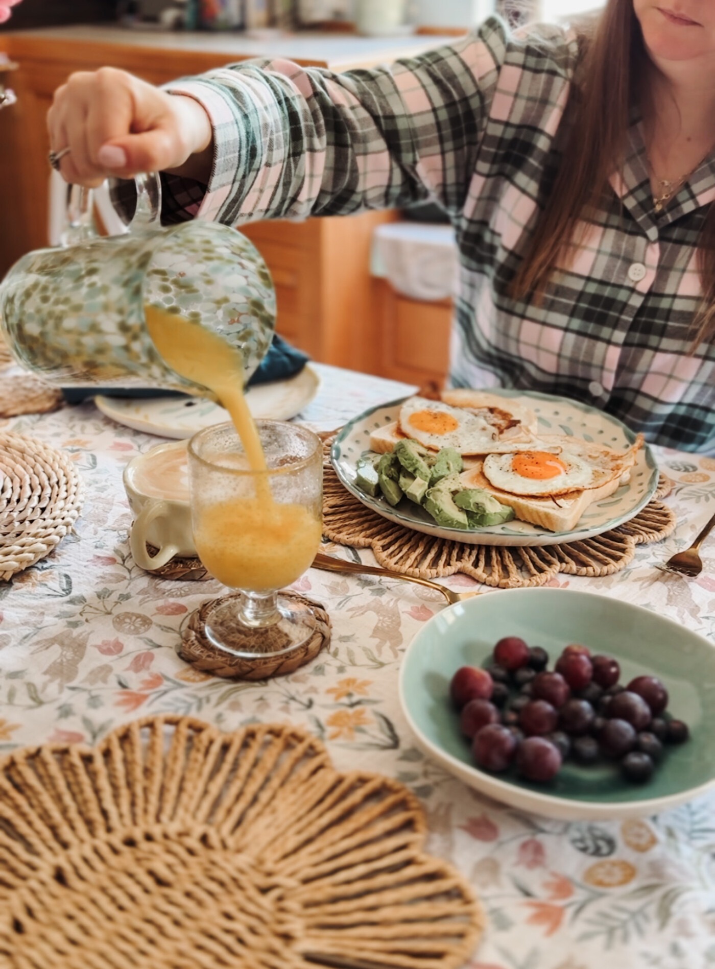 Pouring fresh orange juice at a spring breakfast table wearing British Boxers Burnet Rose Tartan pyjamas