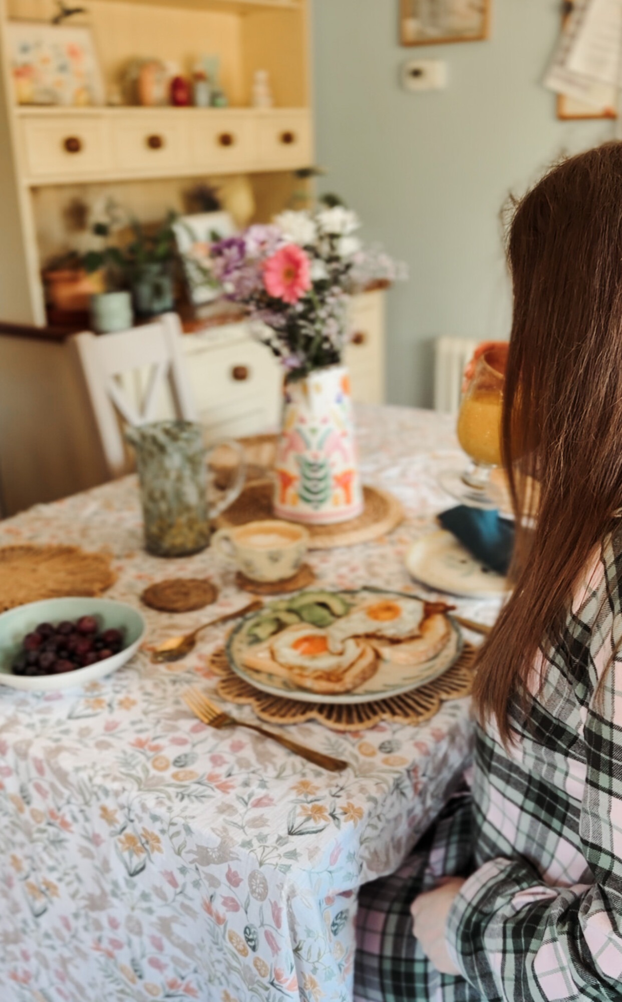 Drinking orange juice at a spring breakfast table wearing British Boxers Burnet Rose Tartan pyjama set