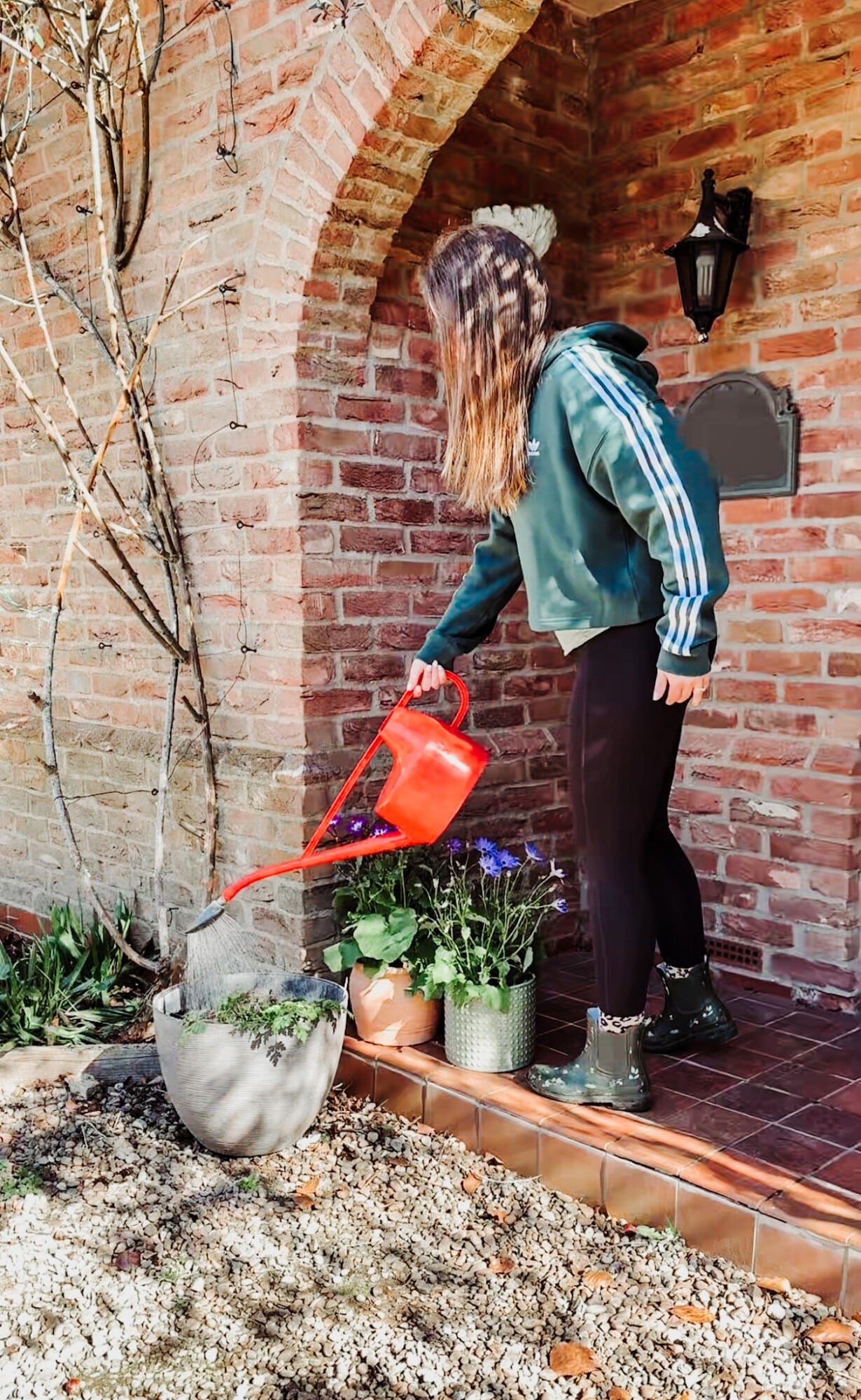 watering plants on a front porch