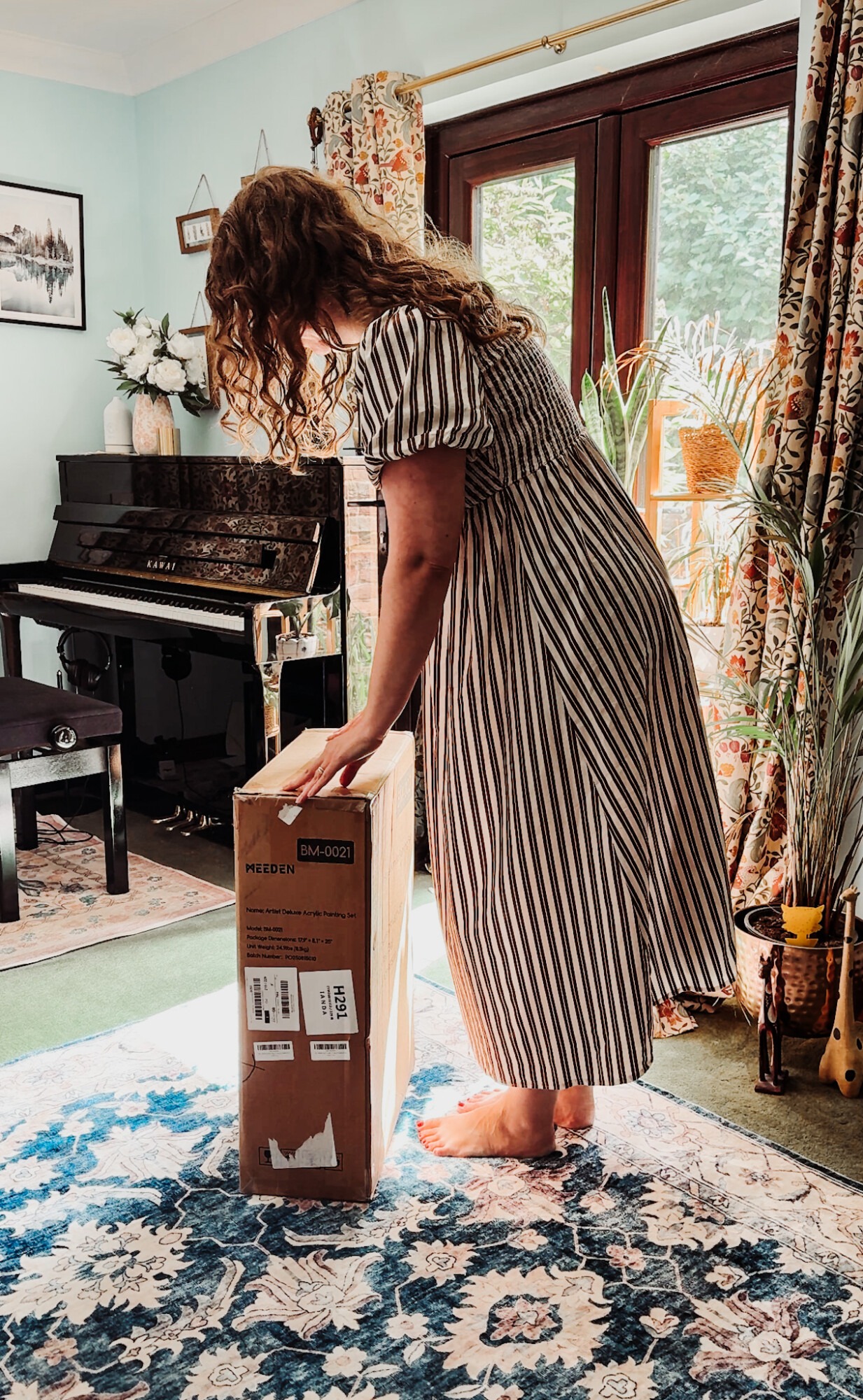 woman opening art supplies in her studio office