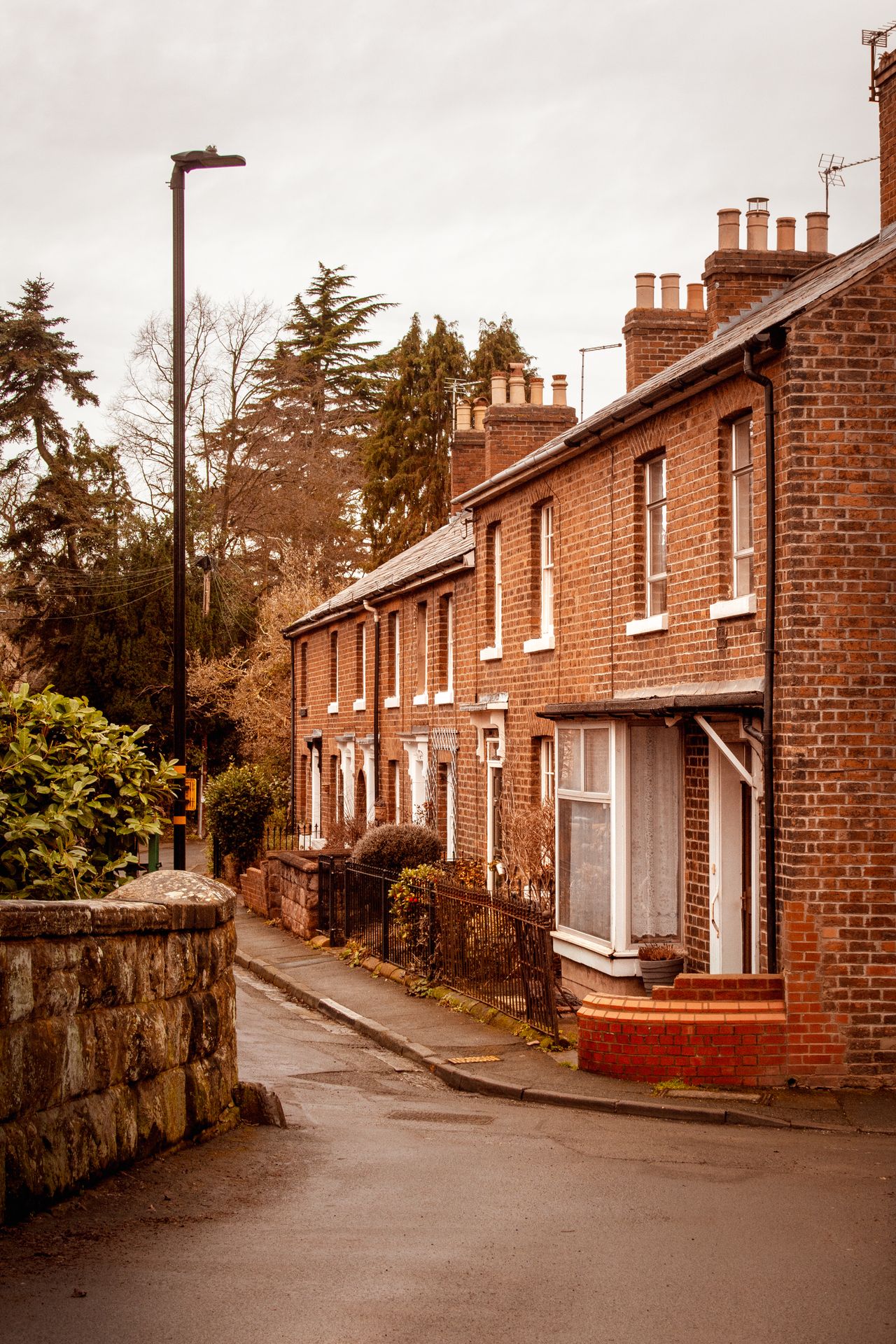 Picturesque row of brick houses on a quiet street in Shrewsbury, England, with a timeless charm.